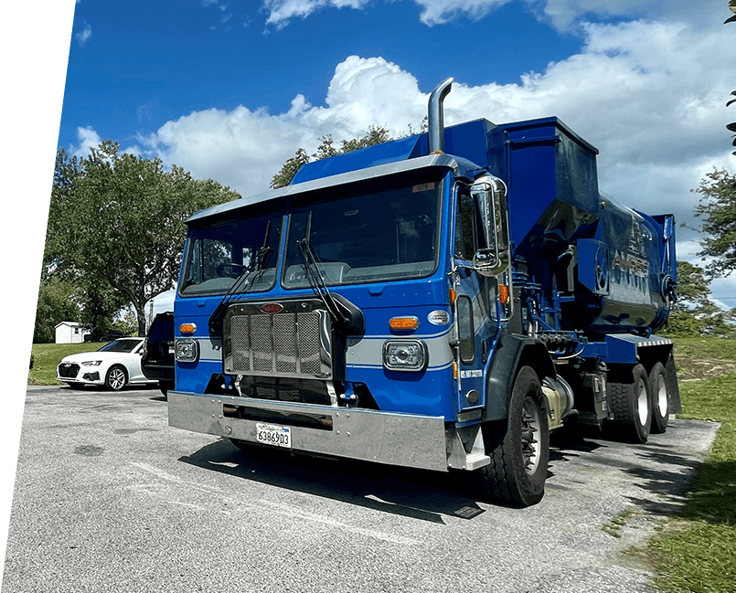 A blue dump truck parked in the parking lot.